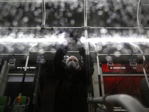 A Tehran Municipality worker cleans a bus to avoid the spread of the COVID-19 illness on February 26, 2020. Iran said Tuesday its coronavirus outbreak, the deadliest outside China, had claimed 15 lives and infected nearly 100 others -- including the country's deputy health minister. The Islamic republic's neighbours have imposed travel restrictions and strict quarantine measures after reporting their first cases in recent days, mostly in people with links to Iran. ATTA KENARE / AFP