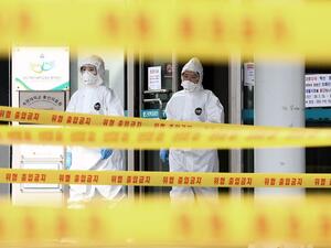 Medical staff members wearing protective gear move inside the yellow control lines at a hospital for patients infected with the COVID-19 coronavirus in Daegu on March 1, 2020. South Korean President Moon Jae-in said on March 1 the government was waging "all-out responses" to contain the novel coronavirus as the country reported 376 new cases, taking the total to 3,526. YONHAP / AFP