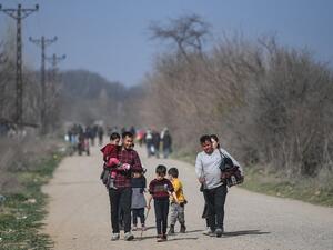 Migrants are on their way to a camp on the Turkish side of the Turkey-Greece border near the Pazarkule crossing gate in Edirne province on March 9, 2020. AFP