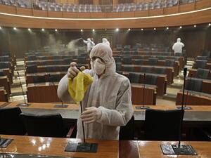 Sanitary workers disinfect the desks and chairs of the Lebanese Parliament in central Beirut on March 10, 2020 amid the spread of coronavirus in the country. ANWAR AMRO / AFP