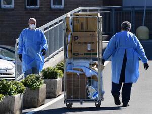 A worker pushes a cart at the hospital in Codogno, southeast of Milan, on March 11, 2020 a day after Italy imposed unprecedented national restrictions on its 60 million people Tuesday to control the deadly COVID-19 coronavirus.  Miguel MEDINA / AFP
