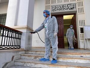 Tunisian public health workers disinfect the entrance to the Ariana tribunal near the capital Tunis, to prevent the spread of the coronavirus COVID-19, on March 12, 2020. FETHI BELAID / AFP