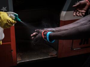 A staff member of Matatu, a privately owned minibus, provides hand disinfectant to passengers, as a preventative measure after the first Kenyan patient with the COVID-19 coronavirus was announced last week, in downtown Nairobi, Kenya, on March 16, 2020. Yasuyoshi CHIBA / AFP