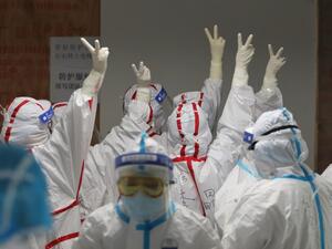 Medical staff cheer themselves up before going into an ICU ward for COVID-19 coronavirus patients at the Red Cross Hospital in Wuhan in China's central Hubei province on March 16, 2020. China reported 12 more imported cases of the novel coronavirus on March 16 as the capital tightened quarantine measures for international arrivals to prevent a new wave of infections. STR / AFP Medical staff cheer themselves up before going into an ICU ward for COVID-19 coronavirus patients at the Red Cross Hospital in Wuhan in China's central Hubei province on March 16, 2020. China reported 12 more imported cases of the novel coronavirus on March 16 as the capital tightened quarantine measures for international arrivals to prevent a new wave of infections. STR / AFP