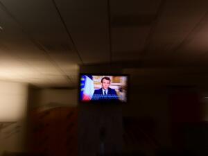 French President Emmanuel Macron is seen on a television screen as he speaks during a televised address to the nation on the outbreak of COVID-19, caused by the novel coronavirus, on March 16, 2020, in Paris. The French president addresses the nation, with many expecting him to unveil more strict home confinement rules in a bid to prevent the virus from spreading. France has closed down all schools, theatres, cinemas and a range of shops, with only those selling food and other essential items allowed to rem