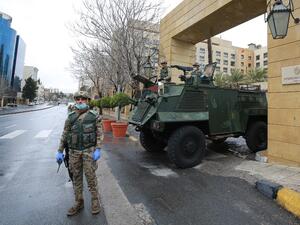 Jordanian soldiers keep watch on March 18, 2020 at an empty avenue in the capital Amman as Jordan takes measures to fight the spread of the coronavirus COVID-19. Khalil MAZRAAWI / AFP
