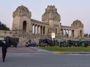 This photo provided by Italian news agency Ansa on March 19, 2020 shows Italian Army trucks parked outside the Monumental cemetery of Bergamo, Lombardy on March 18, 2020, mobilized to transport and bring about sixty coffins to crematoriums in other regions where there are municipalities that have made themselves available to accept them. STRINGER / ANSA / AFP