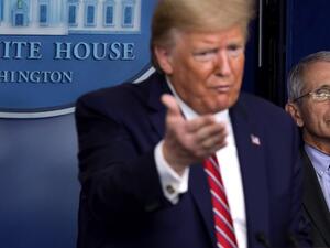 U.S. President Donald Trump speaks as Director of the National Institute of Allergy and Infectious Diseases Dr. Anthony Fauci looks on during a news briefing on the latest development of the coronavirus outbreak in the U.S. at the James Brady Press Briefing Room at the White House March 20, 2020 in Washington, DC. With deaths caused by the coronavirus rising and foreseeable economic turmoil, the Senate is working on legislation for a $1 trillion aid package to deal with the COVID-19 pandemic. President Trum