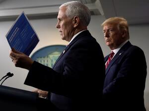 U.S. Vice President Mike Pence speaks as President Donald Trump listens during a news briefing on the latest development of the coronavirus outbreak in the U.S. at the James Brady Press Briefing Room at the White House March 20, 2020 in Washington, DC. ALEX WONG / GETTY IMAGES NORTH AMERICA / AFP