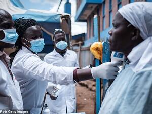 Staff of a NGO measuring a patient's body temperature in Nairobi, Kenya, to check for coronavirus yesterday (file image/AFP)