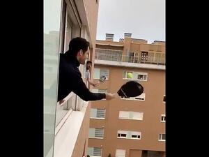 High-level stunts: These men, from an unknown location, played tennis between windows. (Twitter)