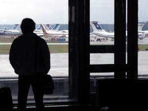 A man looks at planes at the international airport outside Minsk on April 17, 2010 (AFP Photo/Viktor Drachev)