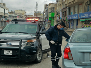 A policeman speaks to a driver at a checkpoint in the Jordanian capital Amman during a nationawide curfew imposed by the authorities in order to control the spread of the novel coronavirus, on March 21, 2020. Khalil MAZRAAWI/AFP A policeman speaks to a driver at a checkpoint in the Jordanian capital Amman during a nationawide curfew imposed by the authorities in order to control the spread of the novel coronavirus, on March 21, 2020. Khalil MAZRAAWI/AFP