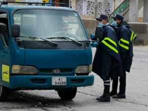 Policemen speak to a truck driver at a checkpoint in the Jordanian capital Amman during a nationawide curfew imposed by the authorities in order to control the spread of the novel coronavirus, on March 21, 2020. Khalil MAZRAAWI / AFP Policemen speak to a truck driver at a checkpoint in the Jordanian capital Amman during a nationawide curfew imposed by the authorities in order to control the spread of the novel coronavirus, on March 21, 2020. Khalil MAZRAAWI / AFP