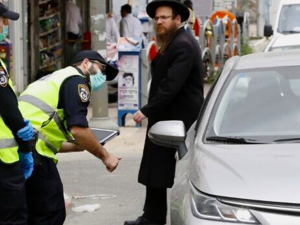 Israeli police talk to a driver at a checkpoint in Bnei Brak, a predominantly ultra-Orthodox city east of Tel Aviv, on March 31, 2020, as part of measures to curb the spread of the coronavirus. (Jack Guez/AFP)