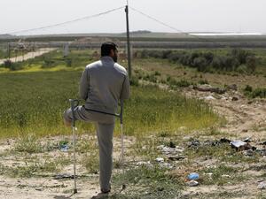 A disabled Palestinian man stands during an event marking Land Day near the Israel-Gaza border as mass rallies planned to commemorate the event were cancelled amid concerns about the spread of coronavirus disease (COVID-19), east of Gaza City, on March 30, 2020. MOHAMMED ABED / AFP