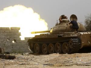 In this file photo taken on June 13, 2019, fighters loyal to the UN-recognised Government of National Accord (GNA) open tank fire from their position in the al-Sawani area south of the Libyan capital Tripoli during clashes with forces loyal to strongman Khalifa Haftar. AFP