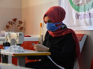 An Iraqi woman sews protective masks at a workshop sponsored by a local relief oranisation in the northern Iraqi city of Mosul on April 1, 2020 amid an increasing need in Iraq for masks for protection against the spread of the coronavirus COVID-19 pandemic. Zaid AL-OBEIDI / AFP