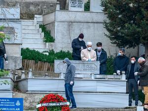 People with protective face mask attend the funeral of Istanbul University Faculty of Medicine's doctor Cemil Tascioglu, the country's first medical professional to pass away from the novel coronavirus (COVID-19) disease, on April 2, 2020, in Istanbul.