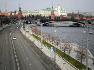 A bicyclist rides on the empty embankment close to the Kremlin in central Moscow on April 3, 2020, amid the spread of the COVID-19, the novel coronavirus. Kirill KUDRYAVTSEV / AFP