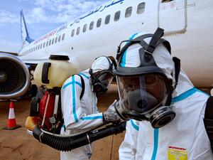 Airport staff members prepare to disinfect a plane after it landed at Juba International Airport in Juba, South Sudan on April 3, 2020. An aircraft that landed in Juba was disinfected of any potential traces of the COVID-19 coronavirus after carrying passengers who had recently arrived in South Sudan from neighbouring Sudan. Alex McBride / AFP