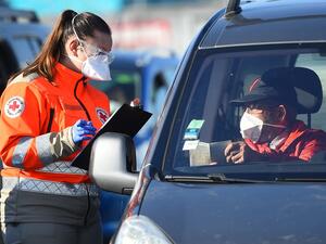 A member of Red Cross ask questions to a man repatriated from Morocco by ferry, around 600 people from European Union and around 230 vehicles arrived at the Sete harbour, southwest of Montpellier, on April 4, 2020, during the strict lockdown in France to stop the spread of the novel coronavirus COVID-19. Sylvain THOMAS / AFP