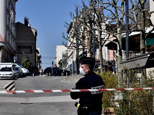 A French Police officer wearing a protective face mask stands in a street in the centre of Romans-sur-Isere, on April 4, 2020, after a man attacked several people with a knife, killing two and injuring seven before being arrested, according to sources close to the investigation. JEFF PACHOUD / AFP