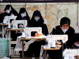 Iranian women, members of paramilitary organisation Basij, make face masks and other protective items at a mosque in the capital Tehran, amid the novel coronavirus pandemic crisis on April 5, 2020. The spread of the virus in Iran has slowed for the fifth day in a row, according to official figures released today by the authorities, who also announced plans for a gradual resumption of certain economic activities starting on April 11. ATTA KENARE / AFP