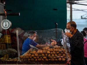 In this file photo taken on March 20, 2020, a man wears a face mask as a preventive measure against the spread of the new coronavirus, COVID-19, as he shops at a municipal market in Caracas. AFP/File