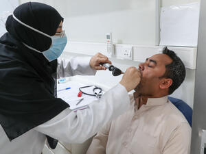 A Saudi nurse checks a patient at a mobile clinic catering for the residents of Ajyad Almasafi district in the holy city of Mecca, on April 7, 2020, which authorities have sealed-off, along with other major cities, amid measures to curb the spread of COVID-19. AFP/File