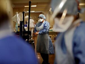 A nurse puts on protective gear prior to tending to a patient infected with COVID-19 at the intensive care unit of the Peupliers private hospital in Paris, on April 7, 2020, on the 22nd day of a strict lockdown in France aimed at curbing the spread of the COVID-19 pandemic, caused by the novel coronavirus. THOMAS COEX / AFP