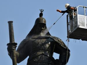 A South Korean worker sprays water to wash the bronze statue of Admiral Yi Sun-Shin, who won a major naval victory over Japan in the 16th century, during a street and park clean-up event for spring at Gwanghwamun square in Seoul on April 9, 2020. Jung Yeon-je / AFP