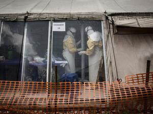 In this file photo taken on March 09, 2019 Health workers are seen inside the 'red zone' of an Ebola treatment centre, which was attacked in the early hours of the morning in Butembo. AFP/File