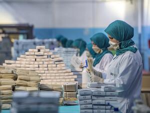 Factory workers package disposable protective masks along a production line in Morocco's Casablanca on April 10, 2020, as the North African country increases mask production due to the COVID-19 coronavirus pandemic. FADEL SENNA / AFP