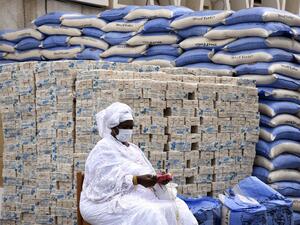 A municipal agent waits for rice bags and soap bars to be distributed by the mayor of Dakar to the residents of the19 municipalities of the Senegalese capital on April 10, 2020. SEYLLOU / AFP