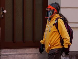 A person wears a visor as a face protection in Berlin's Kreuzberg district on April 11, 2020 amid the novel coronavirus, COVID-19, pandemic. David GANNON / AFP