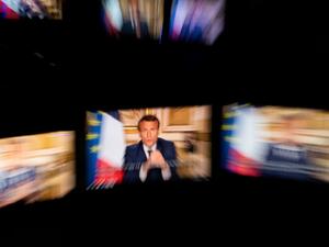 French President Emmanuel Macron is seen on multiple monitors in Paris, as he speaks from the Elysee Palace during a televised address to the nation on April 13, 2020, on the 28th day of a lockdown in France aimed at curbing the spread of the COVID-19 pandemic, caused by the novel coronavirus. The French president in a prime-time televised address announced the coronavirus lockdown in place since March 17, 2020, will go on until May 11, while also outlining how the country will take steps to recover.  Marti