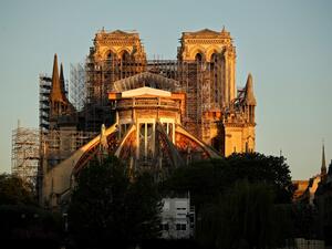 This picture taken on April 14, 2020 shows the Paris' Cathedral Notre Dame at the sunrise on the eve of the first anniversary of the violent fire who destroyed a large part of the monument, on the twenty-nineth day of a lockdown in France to stop the spread of the COVID-19, (the novel coronavirus). One year ago, on April 15, 2019, a fire erupted in Notre-Dame Cathedral in Paris, partly destroying the nearly millenium old building and its precious artworks visited by millions of people a year. THOMAS COEX / 