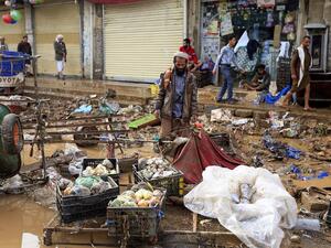 A Yemeni vendor looks at goods he managed to salvage from his stall, damaged by floods following heavy rains in the capital Sanaa, on April 14, 2020. Mohammed HUWAIS / AFP