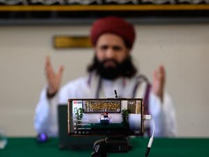 Imam Hassanat Ahmed delivers his Friday broadcast entitled 'Preparing for a Unique Ramadan' via multiple social media platforms from the otherwise empty Noor Ul Islam Mosque on the day before Ramadan commences in the UK, in Bury, Greater Manchester on April 24, 2020. The mosque, like all religious venues, has been closed to worshipers during the national lockdown due to the novel coronavirus COVID-19 pandemic. OLI SCARFF / AFP