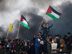 Palestinian protesters wave national flags during clashes with Israeli security forces on the eastern outskirts of Gaza City, near the border with Israel, on January 12, 2018. (AFP Photo/Mohammed Abed) Palestinian protesters wave national flags during clashes with Israeli security forces on the eastern outskirts of Gaza City, near the border with Israel, on January 12, 2018. (AFP Photo/Mohammed Abed)