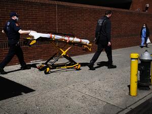 Medical workers walk with a stretcher outside of Montefiore Medical Center April 06, 2020 in the Bronx borough of New York City. AFP