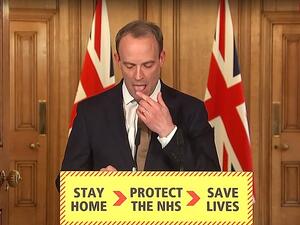 The Foreign Secretary (pictured licking his finger today) was filling in for Boris Johnson as the Prime Minister is self-isolating after testing positive for the deadly bug. (Video Screenshot)