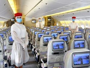Emirates crew onboard wear a protective disposable gown over their uniforms and a safety visor in addition to masks and gloves.