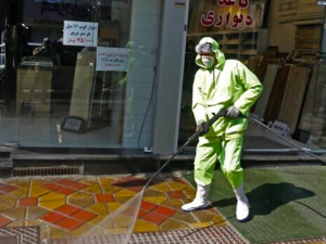 Iranian fire fighters and municipality workers disinfect a street in the capital Tehran for corona virus COVID-19 on March 5, 2020 (STR / AFP)