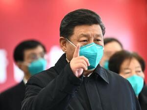 Chinese President Xi Jinping gestures to a coronavirus patient and medical staff via a video link at the Huoshenshan hospital in Wuhan on Tuesday. Photograph: Xie Huanchi/Xinhua/AFP via Getty Images