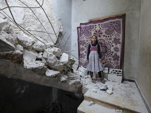 A Syrian girl whose family decided to return home for fear of the COVID-19 pandemic in packed camps for the internally displaced, poses for a picture amid the rubble in her damaged house in al-Nayrab, a village ravaged by pro-government forces bombardment near the M4 strategic highway, in Syria's northwestern Idlib province, on May 3, 2020. Bakr ALKASEM / AFP