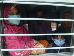 Migrant labourers with their family members sit near a train window as they arrive from the Western Indian state of Rajasthan through a special train organised to bring back migrant labourers and pilgrims to their hometowns at the Dankuni Railway station after the government eased a nationwide lockdown imposed as a preventive measure against the COVID-19 coronavirus, some 25 Km north of Kolkata on May 5, 2020. Dibyangshu SARKAR / AFP
