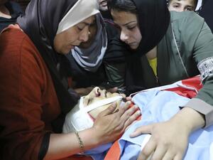 A Palestinian mother and relatives mourn over the body of Zaid Qaysia, 15, during his funeral at the al-Fawar refugee campo south the West bank town of Hebron on May 13, 2020. Israeli forces shot dead the Palestinian teenager during clashes in the occupied West Bank, the Palestinian health ministry said, as US Secretary of State Mike Pompeo visited Israel. HAZEM BADER / AFP