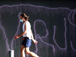 A man clad in mask due to the COVID-19 coronavirus pandemic walks past a graffiti reading "VIRUS" on the facade of a fortified local branch of the Bank of Beirut in the Lebanese capital on May 18, 2020. Lebanon is ready to terminate a 23-year-old dollar peg and float the pound, but only after it secures billions in aid, Finance Minister Ghazi Wazni had said on May 15. After talks started with the International Monetary Fund (IMF) on a plan to rescue Lebanon's crisis hit economy, he also said banking sector restructuring would entail halving the number of lenders. PATRICK BAZ / AFP A man clad in mask due to the COVID-19 coronavirus pandemic walks past a graffiti reading "VIRUS" on the facade of a fortified local branch of the Bank of Beirut in the Lebanese capital on May 18, 2020. Lebanon is ready to terminate a 23-year-old dollar peg and float the pound, but only after it secures billions in aid, Finance Minister Ghazi Wazni had said on May 15. After talks started with the International Monetary Fund (IMF) on a plan to rescue Lebanon's crisis hit economy, he also said banking sector